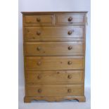 A 20th century pine chest of two small over five long drawers, raised on bracket feet with shaped