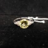 A boxed 10ct white gold diamond and citrine ring, centrally set with a faceted circular citrine