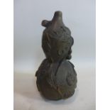 A Chinese hand-carved hardwood double gourd, decorated in relief with a fruiting vine, unsigned,