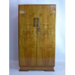 An Art Deco style walnut veneered cabinet, raised on bracket feet, H.142 W.77 D.47cm