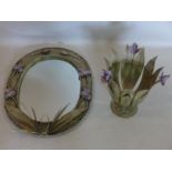 A cream painted metal oval mirror, 65 x 52cm, with a matching jardiniere, 34 x 30cm, both adorned