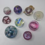 An assorted collection of 8 glass paperweights, to include Caithness examples, Selkirk, a red