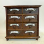 A German oak spice chest of eight small drawers, each with porcelain plaques, H.25.5 W.26 D.10cm