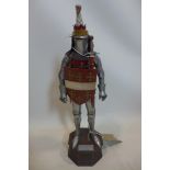 A replica statue of a knight, bearing plaque for 'Thomas Beauchamp, Earl of Warwick, 1345-1401',