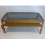 A mid 20th century teak coffee table, with smoked glass top, H.39 W.85 D.44cm
