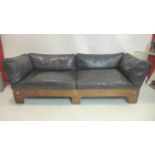 A 1970's Danish style exotic hardwood sofa by Pirelli Ltd, UK, with black leather upholstery and