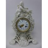 A 19th century porcelain mantle clock in the Baroque taste adorned with putti and dove final, with