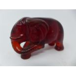 A Chinese red amber elephant, H.5.5 W.9.5 D.4cm
