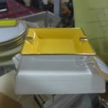 6 individually boxed Legle Limoges medium-sized porcelain ashtrays: 2 yellow and gold, 2 black and