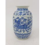 An early 20th century Chinese porcelain vase, hand-painted in blue and white with dragons amongst