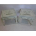 A pair of Chinese white lacquered side tables, with glass tops, decorated with blossoming trees,