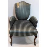 An unusual 19th century armchair, recently upholstered, raised on mahogany legs and castors