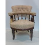 A Victorian mahogany tub chair, with pink upholstery, on turned supports and castors, H.86cm