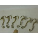 A set of 6, Art Nouveau large brass coat hooks each of whiplash, tendril form 18.5 x 4cm each