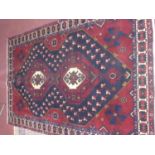 A North West Persian Vis carpet, double pole diamond medallion with repeating petal motifs on a