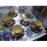 A Copeland china part coffee service, gilt decorated with floral swags on a blue ground,