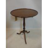 A Georgian mahogany tilt top table, on turned supports and outswept feet, H.73cm Diameter 50cm