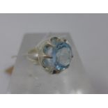 A sterling silver ring centrally set with a circular, faceted round icy-blue topaz, Size: F 1/2,