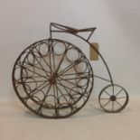 A vintage iron wine rack in the form of a penny farthing bike