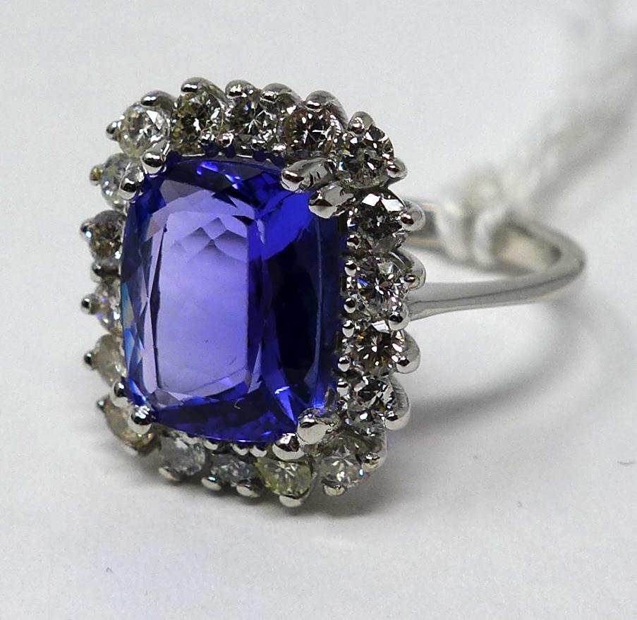 An 18ct white gold brilliant cut diamond and tanzanite ring, Size: N, 5.2 g. Central tanzanite: 11 x