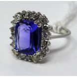 An 18ct white gold brilliant cut diamond and tanzanite ring, Size: N, 5.2 g. Central tanzanite: 11 x