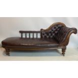 A William IV mahogany chaise longue with button back lather upholstery, raised on turned legs and