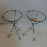 A pair of contemporary glass topped circular occasional tables, raised on three bird feet, H.78cm