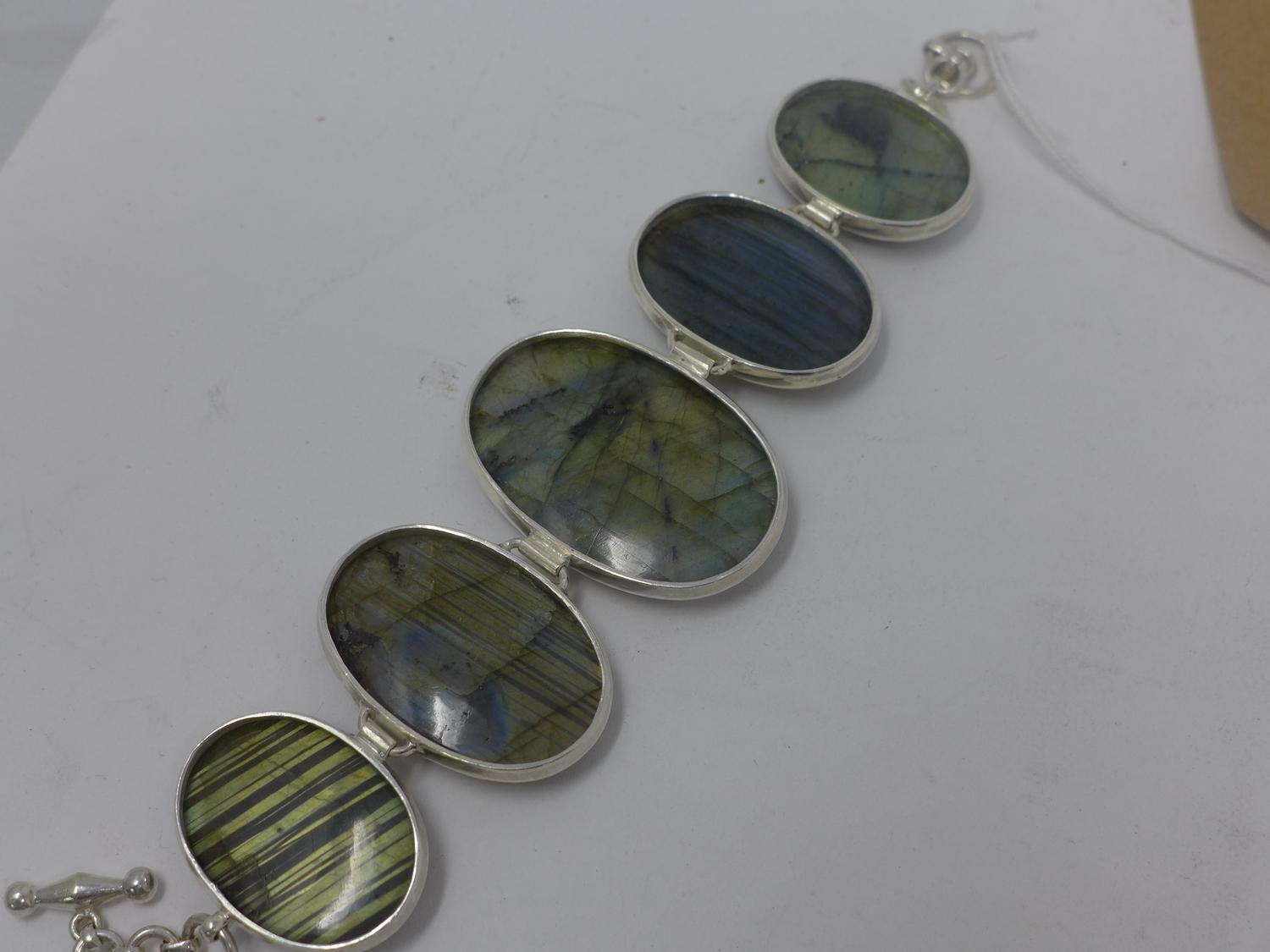 A sterling silver and labradorite bracelet composed of 5 oval, polished labradorite cabochon - Image 2 of 2