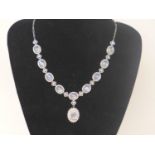 A sterling silver moonstone and white sapphire studded drop necklace interset with 10 oval