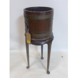 A late 19th/early 20th century brass bound wooden bucket on stand, H.78cm