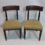 A pair of Regency mahogany side chairs, the seats with floral upholstery, raised on reeded supports