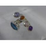 A sterling silver ring set with cabochon blue topaz, amethyst, moonstone, garnet and iolite, ring: