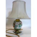 A small Chinese vase converted to a lamp, with gilt metal scrolling mounts, decorated with