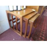 A 20th century teak nest of 3 tables