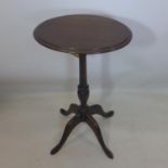 A 19th century mahogany lamp table with oval top raised on 4 splayed legs, H.55cm