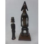 A tribal hardwood mumuye statue together with one other