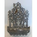 A 19th century Eastern wall mounted wooden shelf inlaid with mother of pearl and pierced decoration,