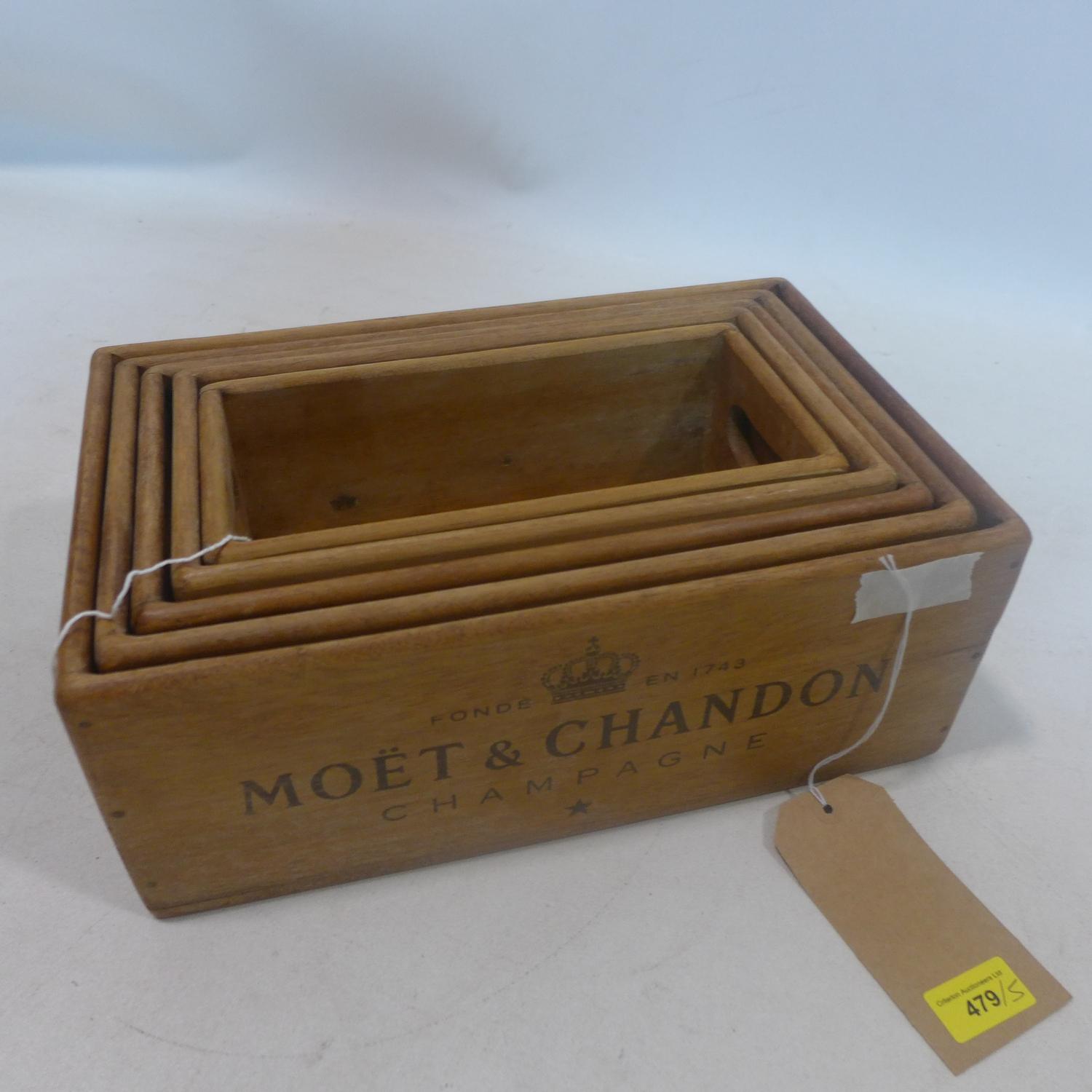 A set of five graduating wooden boxes, marked Moet & Chandon