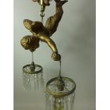 A 20th century gilt plaster ceiling light in the form of a cherub