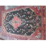 A North West Persian Nahawand carpet, central floral medallion with repeating petal motifs on a