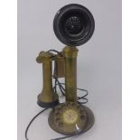 A vintage brass stick telephone