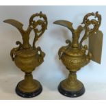A pair of Victorian gilt metal ewers on marbles bases, H.32cm