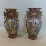A pair of Chinese porcelain vases, decorated with vignettes of ladies amongst scrolling foliage on a