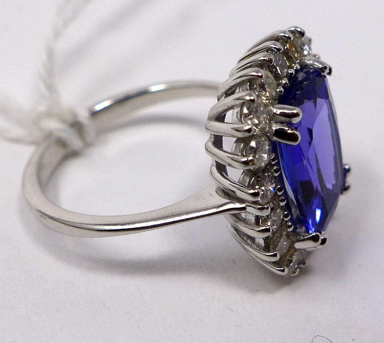 An 18ct white gold brilliant cut diamond and tanzanite ring, Size: N, 5.2 g. Central tanzanite: 11 x - Image 2 of 2