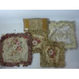 Four embroidered cushion covers, with floral decoration and tassels, together with a small cushion