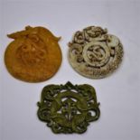 Three Chinese, hand-carved hardstone pendants/amulets in shades of green, orange and white, 6x 7.