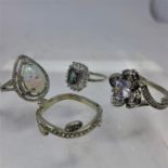 4 boxed sterling silver and gem-set rings, set with an opalite, mystic topaz and white crystals