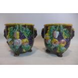 A pair of late 19th/early 20th century Majolica jardinieres each on 3-paw feet, 21 x 20cm