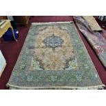 A 20th century Kirman silk carpet with central floral medallion