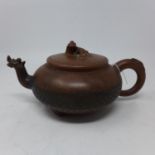 A 19th century Chinese terracotta tea pot with character marks to base and lid, H.11 W.23 D.15cm